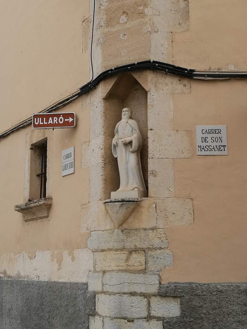 Sculpture of Mallorcan philosopher Ramon Llull in a house facade in Campanet village.