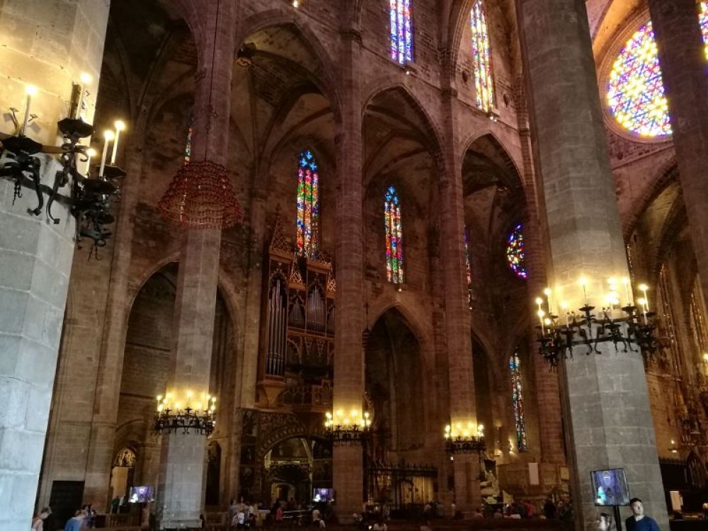Chandeliers made of wrought iron by Antoni Gaudi hanging on columns inside the cathedral of Palma.