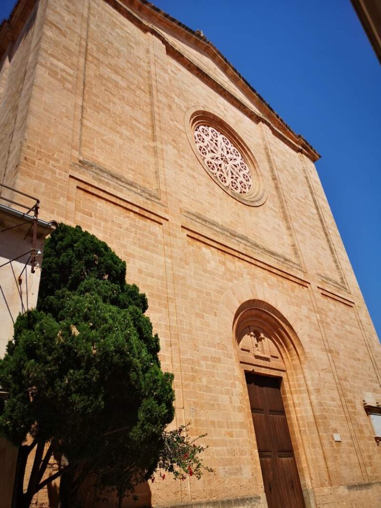Front facade with entrance and rosette of the Sant Miquel church in Llucmajor town, Mallorca.