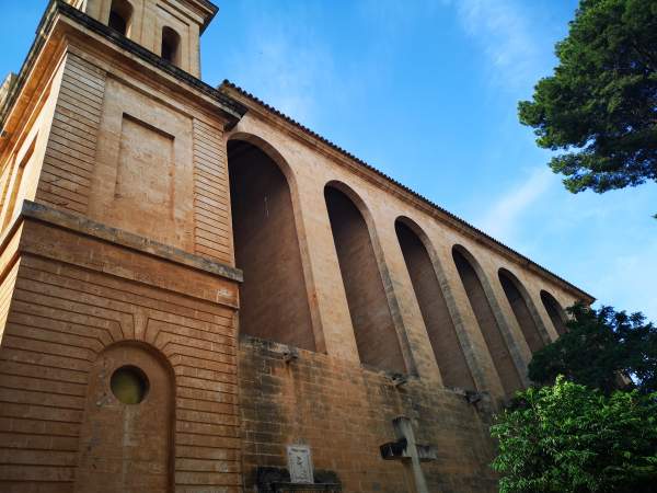 Neoclassicism facade with arch gallery of the Sant Julia church in Campos, Mallorca.