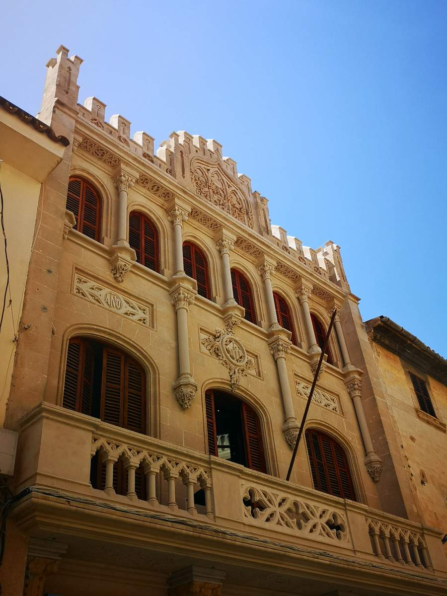 Building belonging to the Forment Agricola with beautiful facade of Modernism and Neo-Gothic in Llucmajor town, Mallorca.