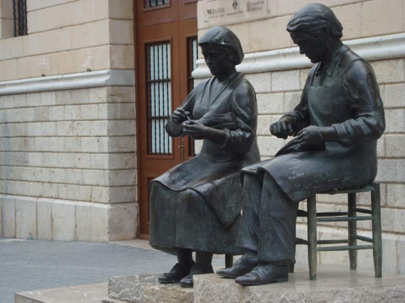 Sculpture of a man and woman sewing shoes as a commemoration to the shoe industry in Inca, Mallorca, Spain.