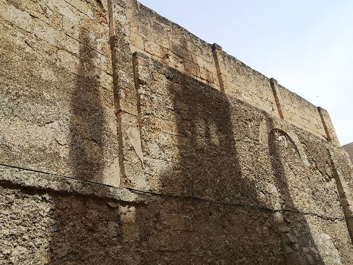 Shadow on the massive walls that enclosures the old convent of Monestir Concepcionista in Sineu, Mallorca.