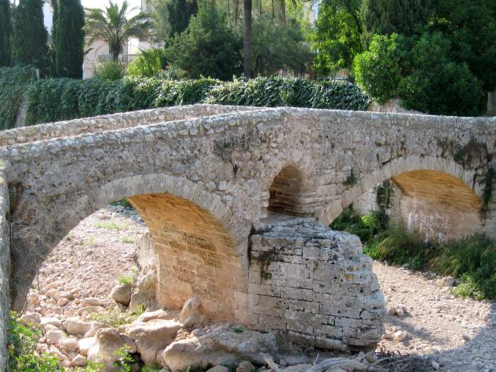 Ancient Roman bridge called 'Pont Roma' in Pollenca old town, Mallorca, Spain.