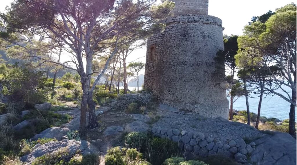 Old coastal watchtower of Torre de sa Pedrissa on the hills above the cove of Cala Deia, Mallorca, Spain.