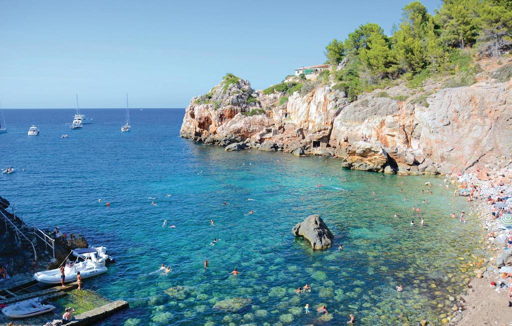 Cala Deia beach nestled in a rocky cove, Mallorca island, Spain.