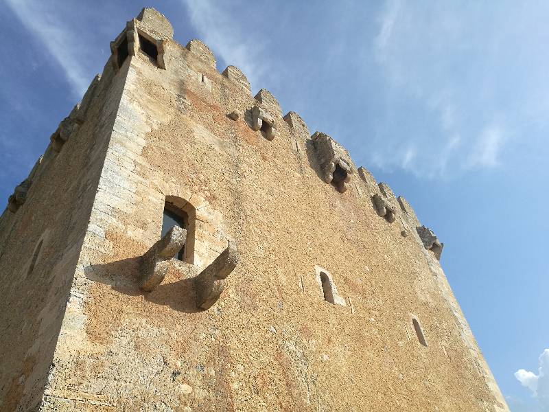 Medieval fortress and watchtower of Torre de Canyamel in Mallorca, seen from below the massive fortified walls.