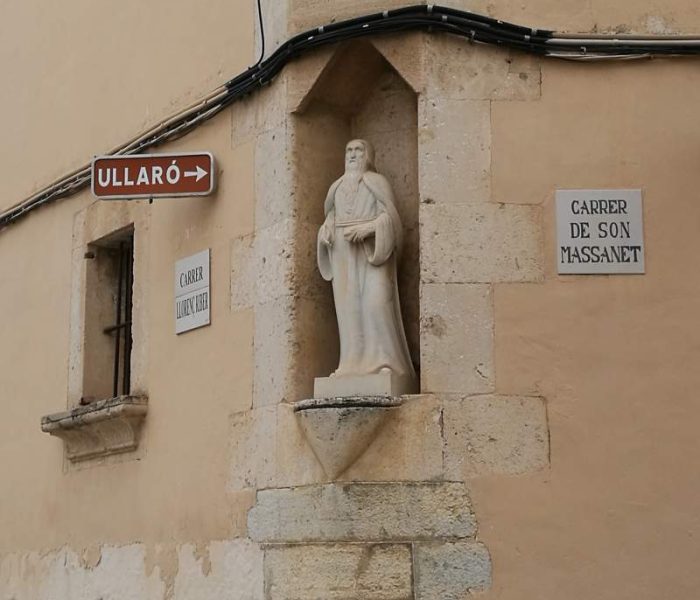 Sculpture of Mallorcan philosopher Ramon Llull in a house facade in Campanet village.
