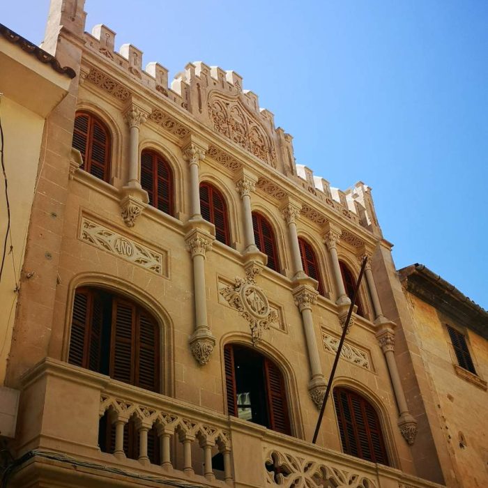 Building belonging to the Forment Agricola with beautiful facade of Modernism and Neo-Gothic in Llucmajor town, Mallorca.