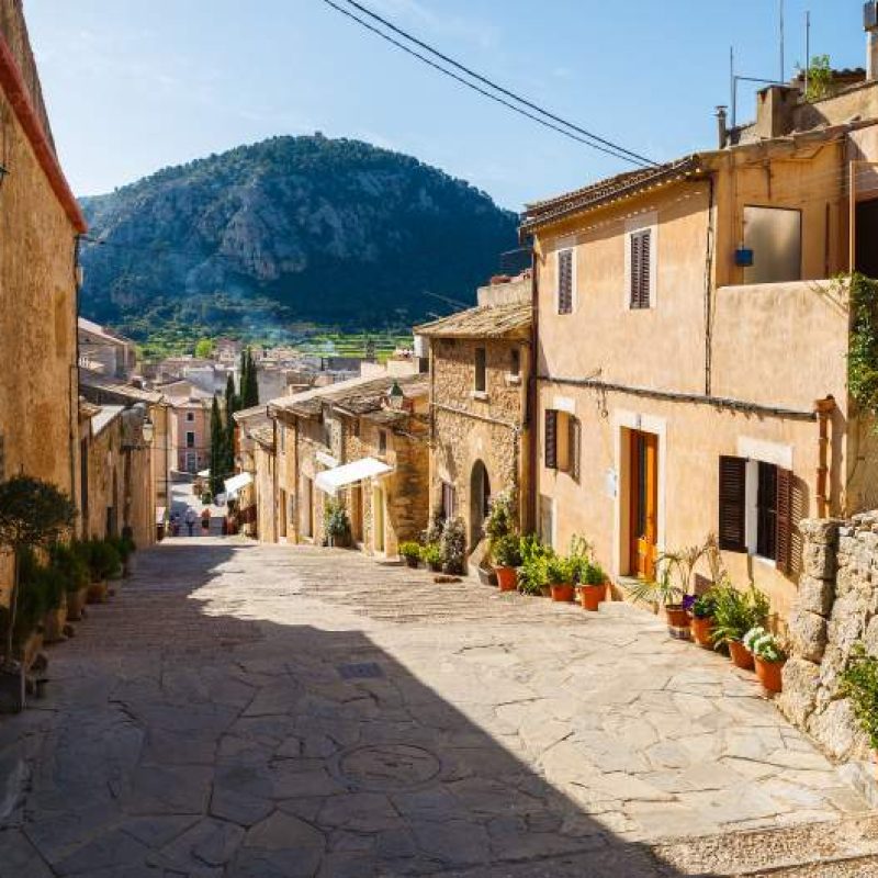 Charming old town of Pollenca, Mallorca island, Spain, with a mountain rising in the horizon.